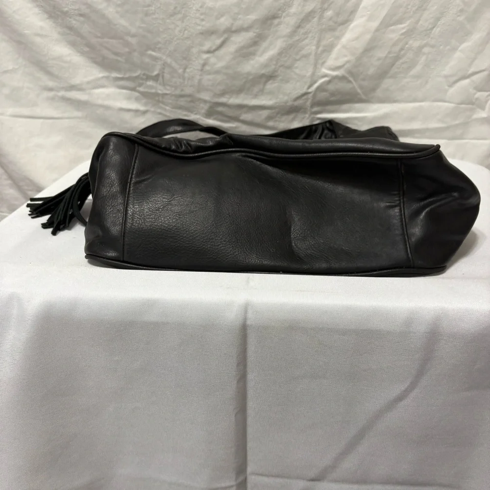 Black tote bag with a tassel accent. - Picture 8 of 12